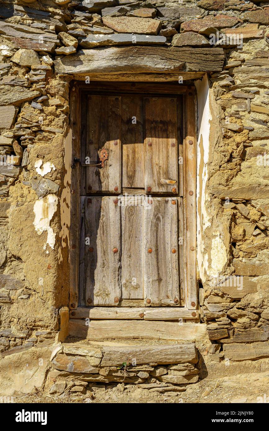 Old wooden door in medieval stone house Stock Photo - Alamy