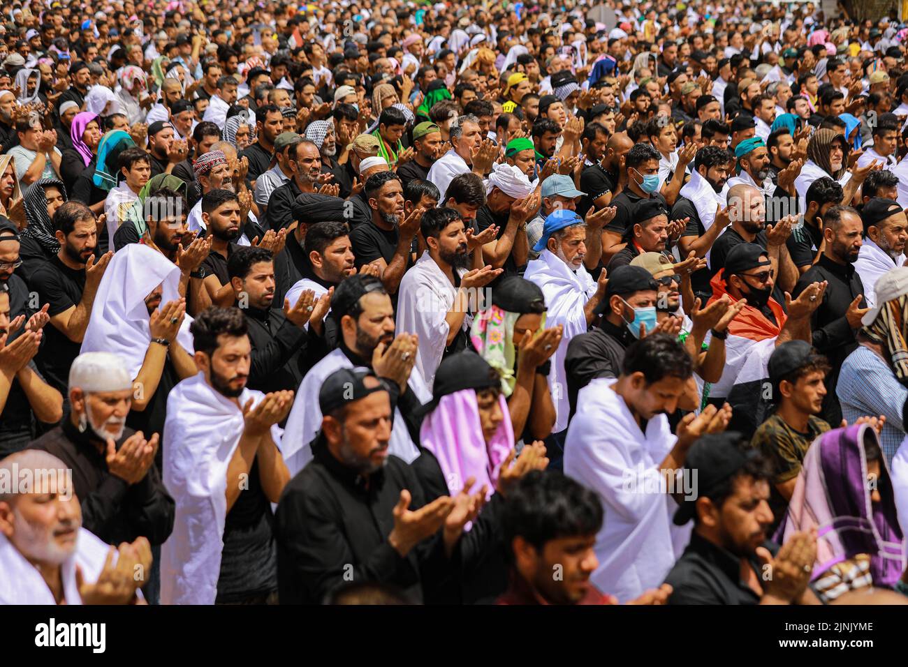 Baghdad, Iraq. 12th Aug, 2022. Supporters of Iraq's influential Shiite cleric Muqtada al-Sadr, attend Friday prayers nearby the Iraqi Parliament at Baghdad's Green Zone. Credit: Ameer Al-Mohammedawi/dpa/Alamy Live News Stock Photo