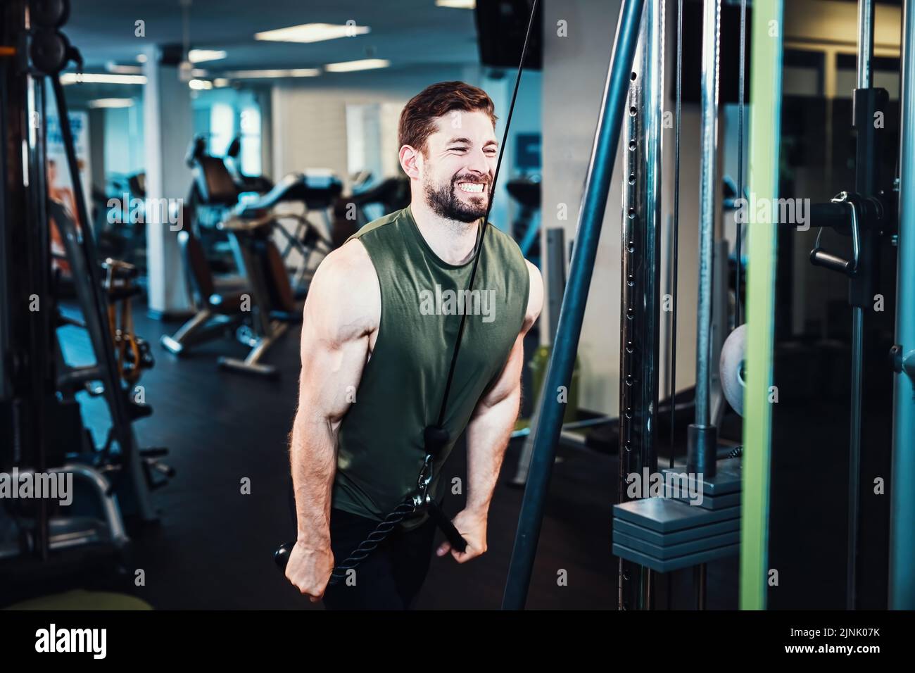 A man doing pulldown exercise at lat pull machine with rope handle
