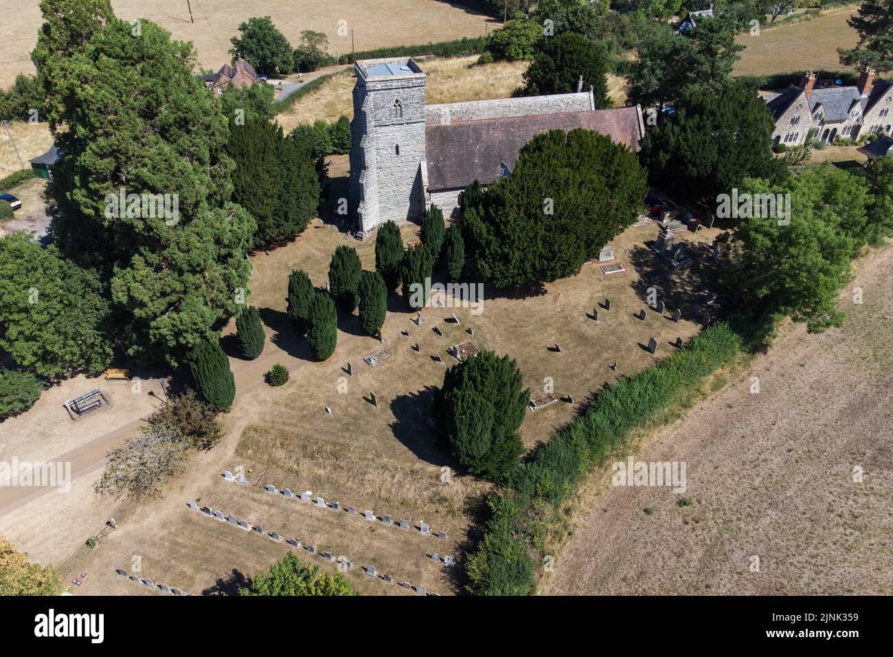 Forthampton, Gloucestershire August 12th 2022 - The small historic hamlet of Forthampton in Gloucestershire has been hit hard by drought conditions with 2 ponds dried up and the church, St. Mary the Virgin, is surrounded by brown dry grass. Credit: SCOTT CM/Alamy Live News Stock Photo