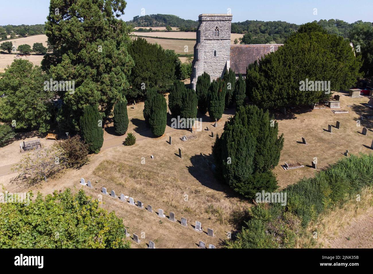 Forthampton, Gloucestershire August 12th 2022 - The small historic hamlet of Forthampton in Gloucestershire has been hit hard by drought conditions with 2 ponds dried up and the church, St. Mary the Virgin, is surrounded by brown dry grass. Credit: SCOTT CM/Alamy Live News Stock Photo