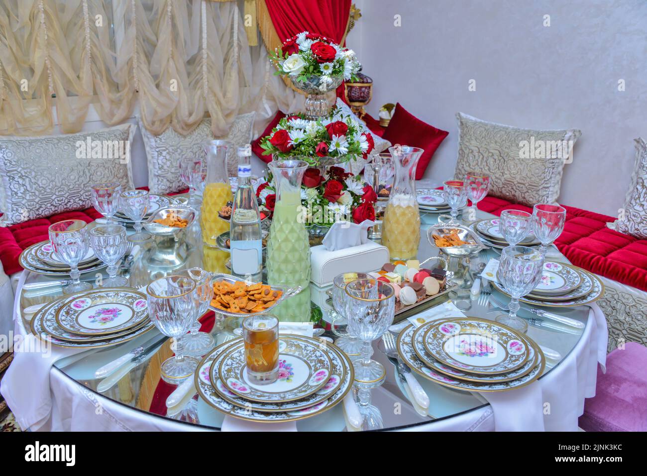 Moroccan salon with wedding table plates, cups and chairs Stock Photo