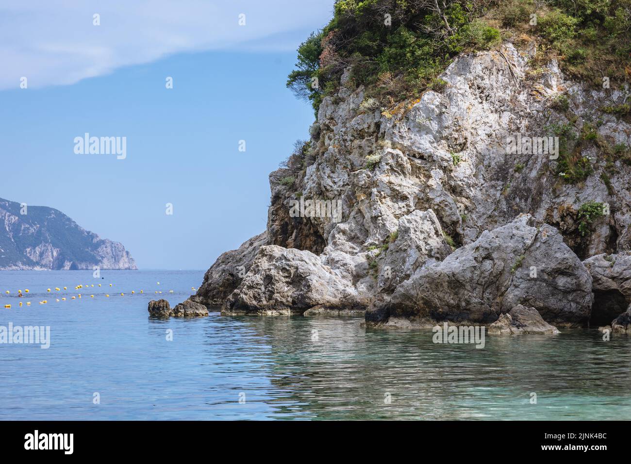 Rocks seen from Agios Spyridonas beach, largest beach in Palaiokastritsa famous resort town on Greek Island of Corfu Stock Photo