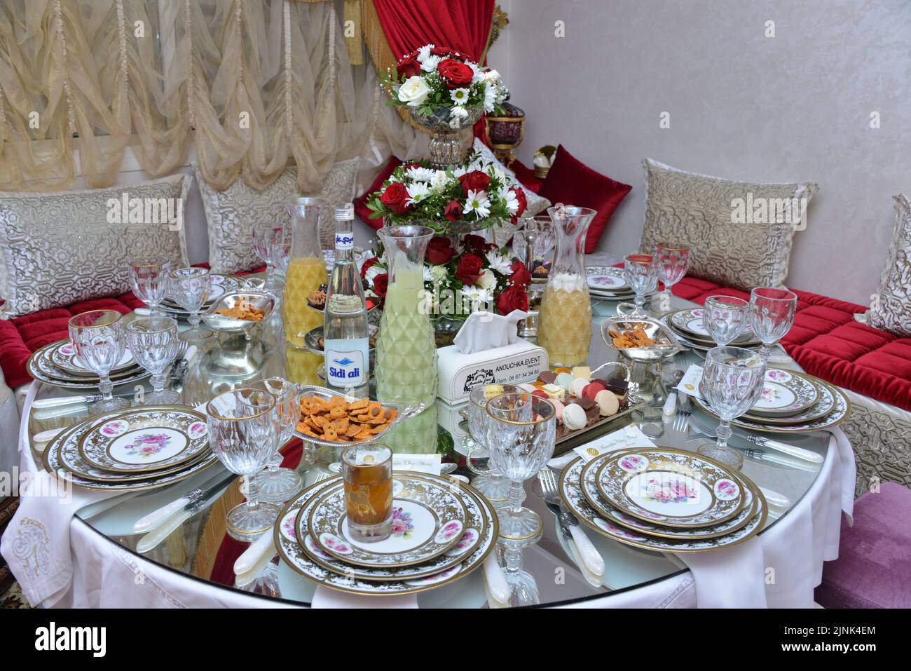 Moroccan salon with wedding table plates, cups and chairs Stock Photo