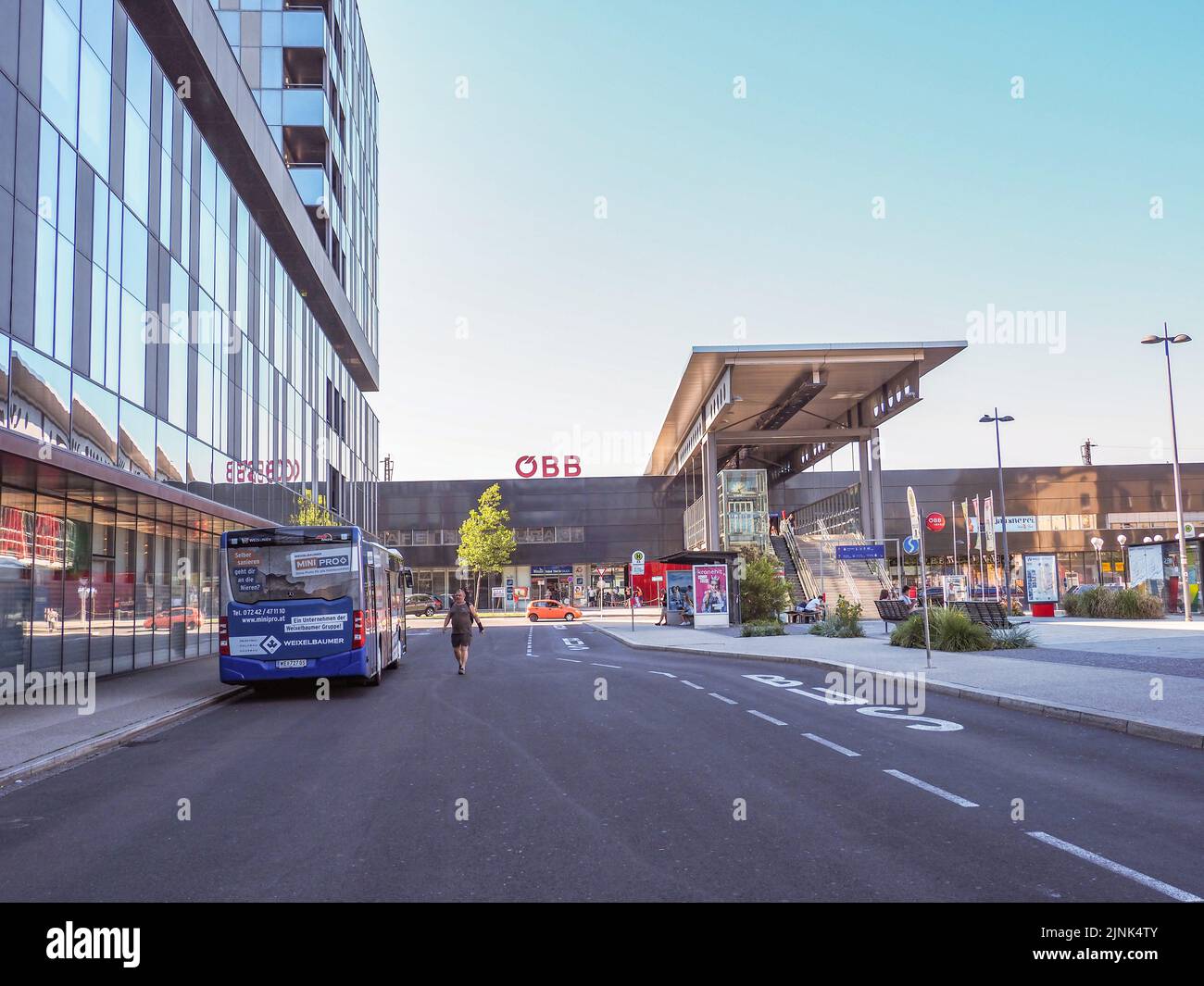 The bus is parked at the bus stop near the railway station Wels Stock Photo Alamy
