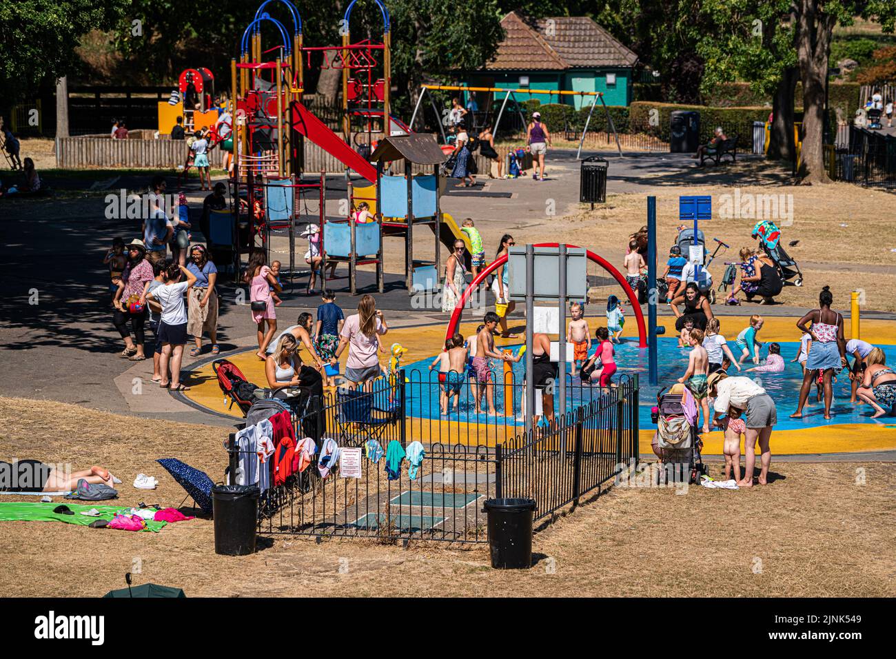 Wimbledon London, UK. 12 August 2022 . Families cooling off around the fountains  in Wimbledon park south west London as temperatures are expected to hit up to 37c this weekend . The environment agency has declared drought  across eight areas of England  due to the prolonged dry conditions Credit. amer ghazzal/Alamy Live News Stock Photo