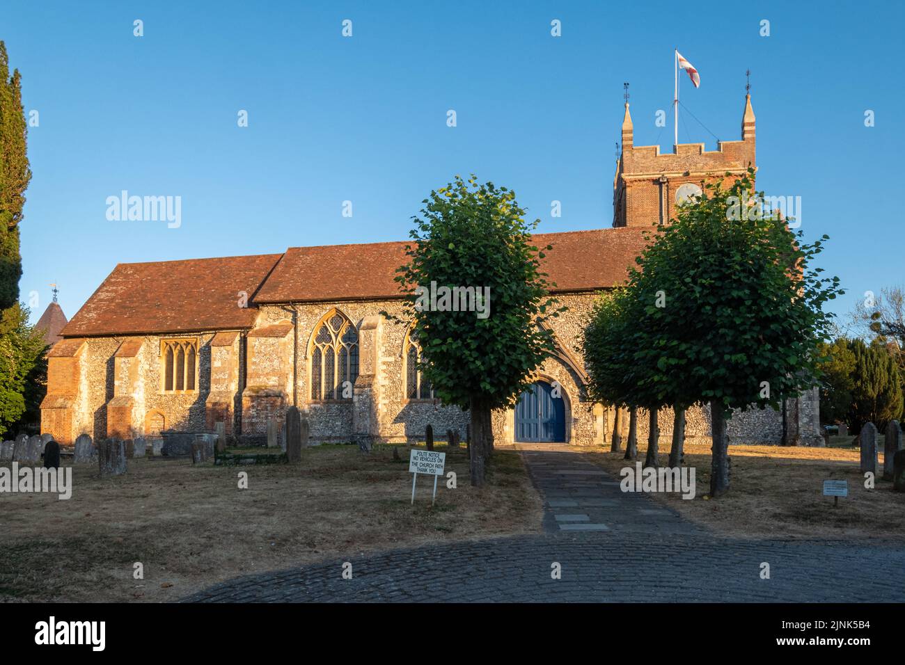 All Saints Church in Odiham village, Hampshire, England, UK, a grade I listed building, on a sunny summer evening Stock Photo