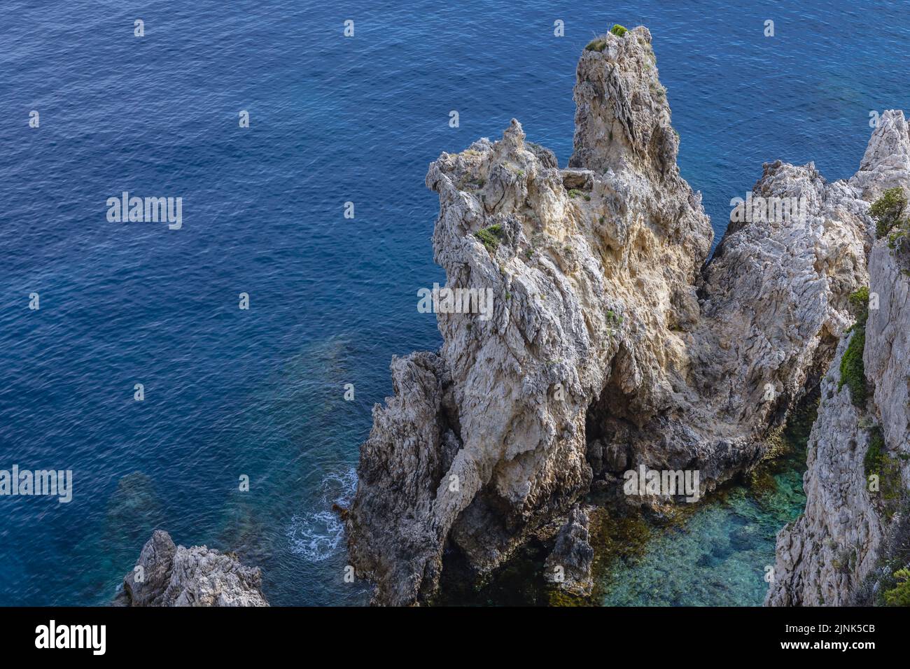 Rocky shore in Palaiokastritsa famous resort town on Greek Island of Corfu Stock Photo