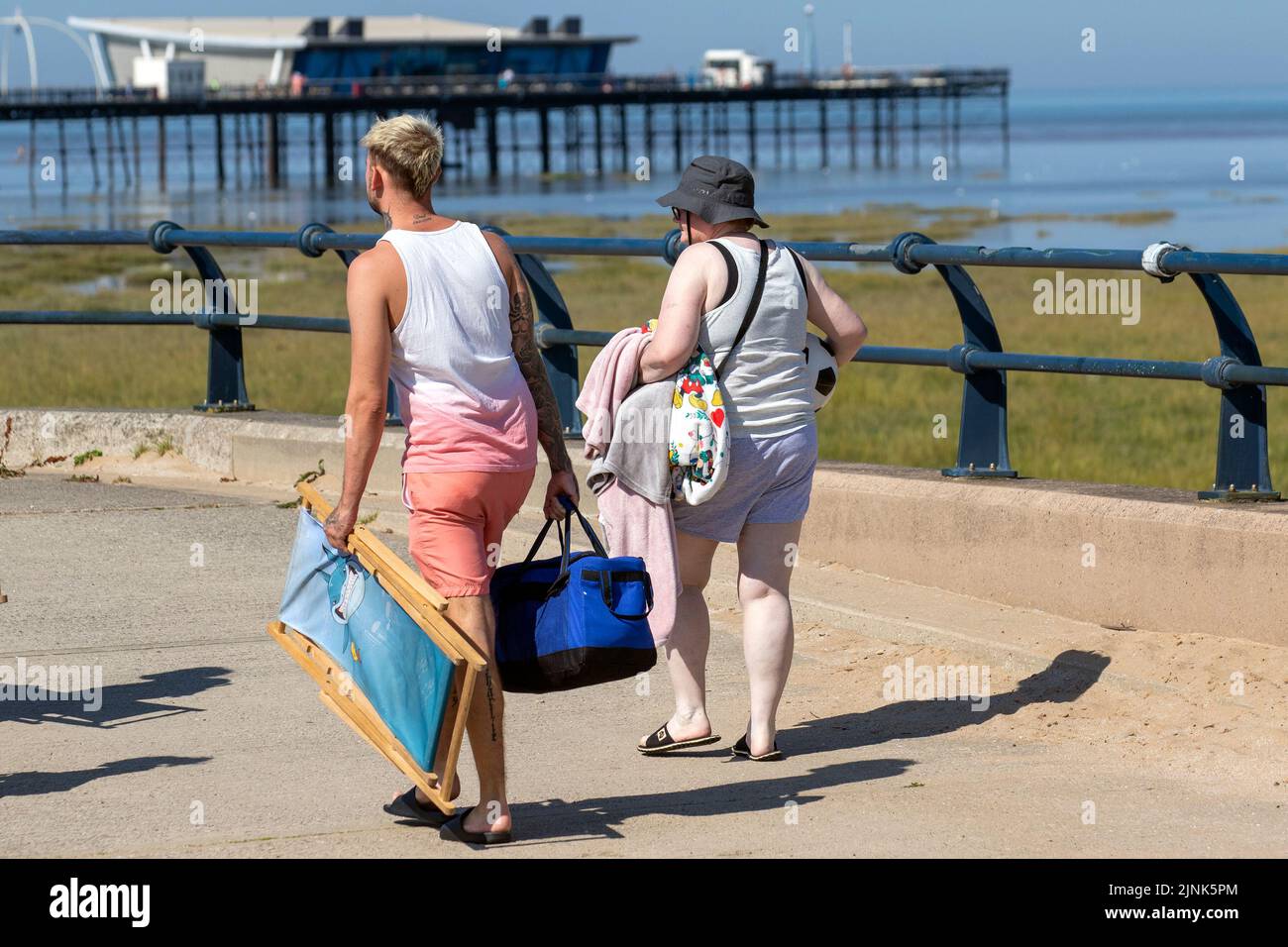 Southport, Merseyside, UK Weather.  12 August 2022. The sandy beaches of the seaside resort are packed with people, tourists, day-trippers, swimmers, and sun worshippers who come to enjoy the hot, sunny summer weather and the scorching 29C local temperatures. As the high tide reduced the number of open areas on the seashore, and the seaside beach esplanade.  Credit; MediaWorldImages/AlamyLiveNews Stock Photo