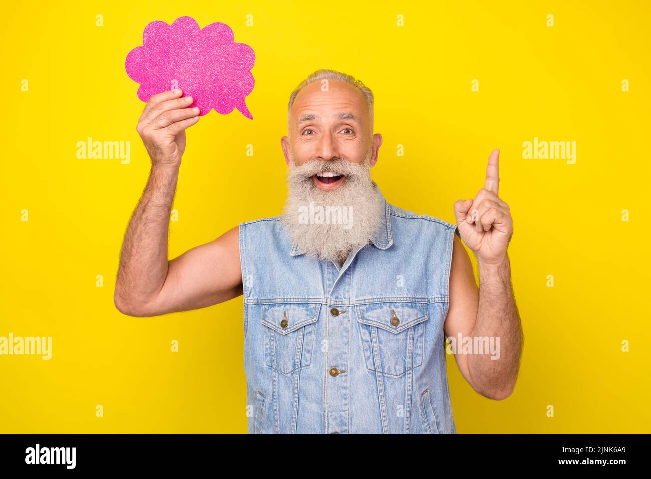Photo of thoughtful clever retired guy wear jeans waistcoat holding mind cloud empty space pointing finger isolated yellow color background Stock Photo