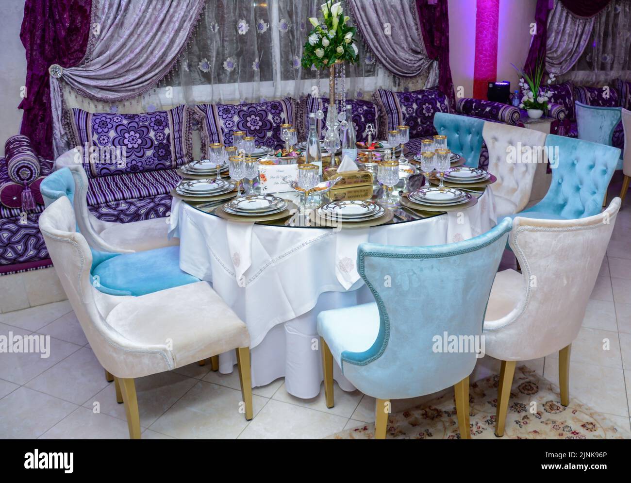 Moroccan salon with wedding table plates, cups and chairs Stock Photo