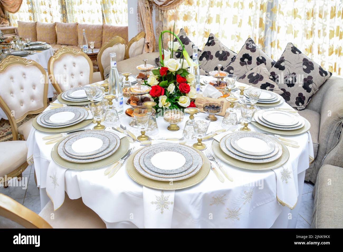 Moroccan salon with wedding table plates, cups and chairs Stock Photo