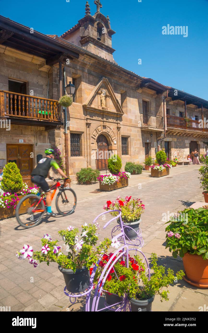 Cyclist in the main street. Riocorvo, Cantabria, Spain. Stock Photo
