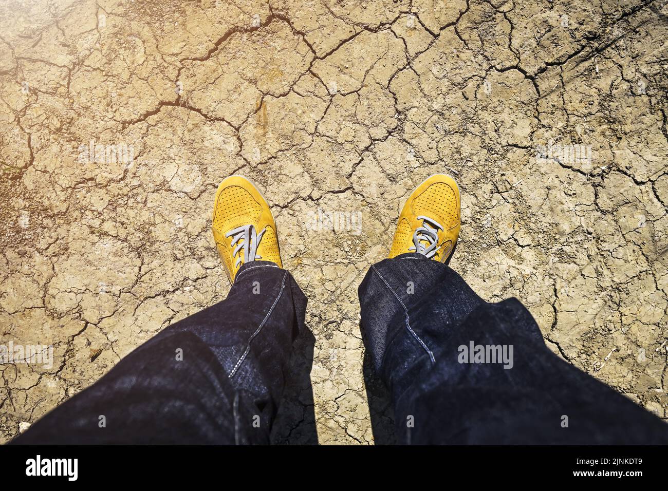 Man Standing On Dry Broken Earth Symbol Photo Climate Change Heat Wave And Drought Stock Photo