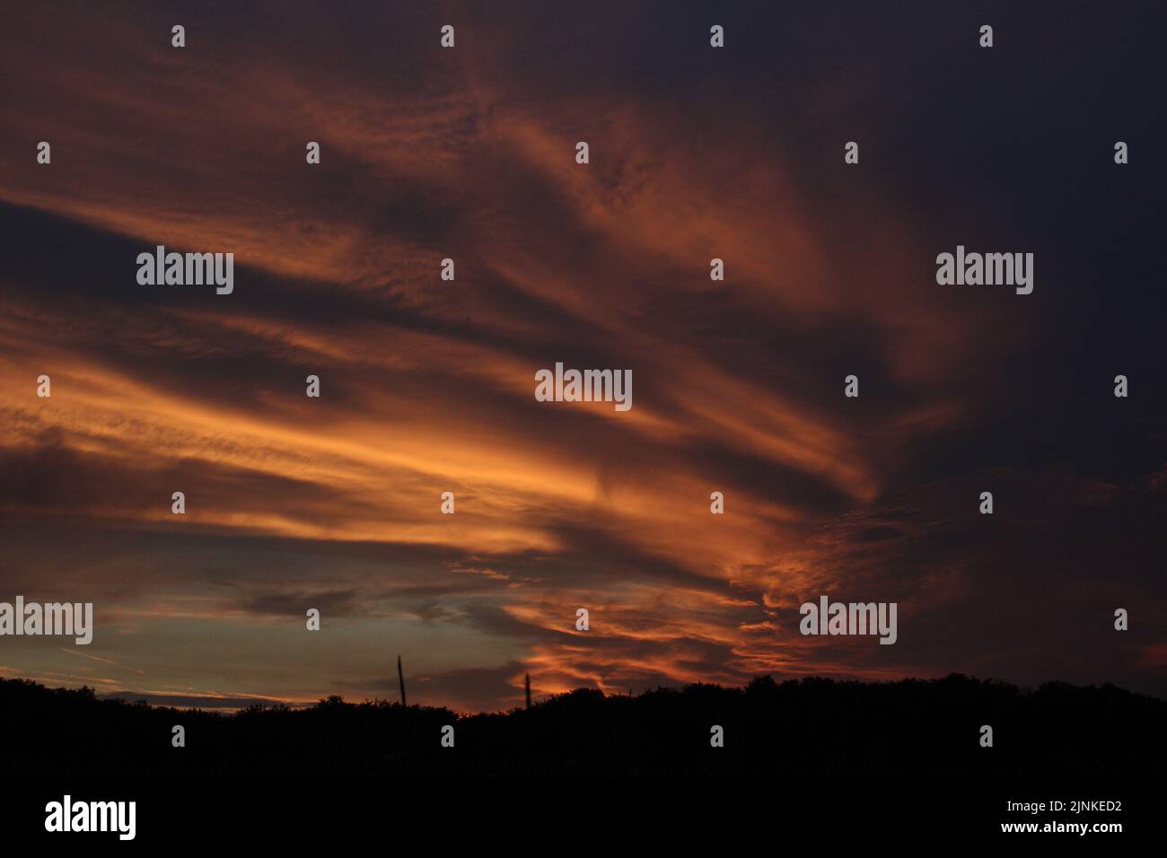 A breathtaking view of a red fire cloudy sky during sunset Stock Photo ...