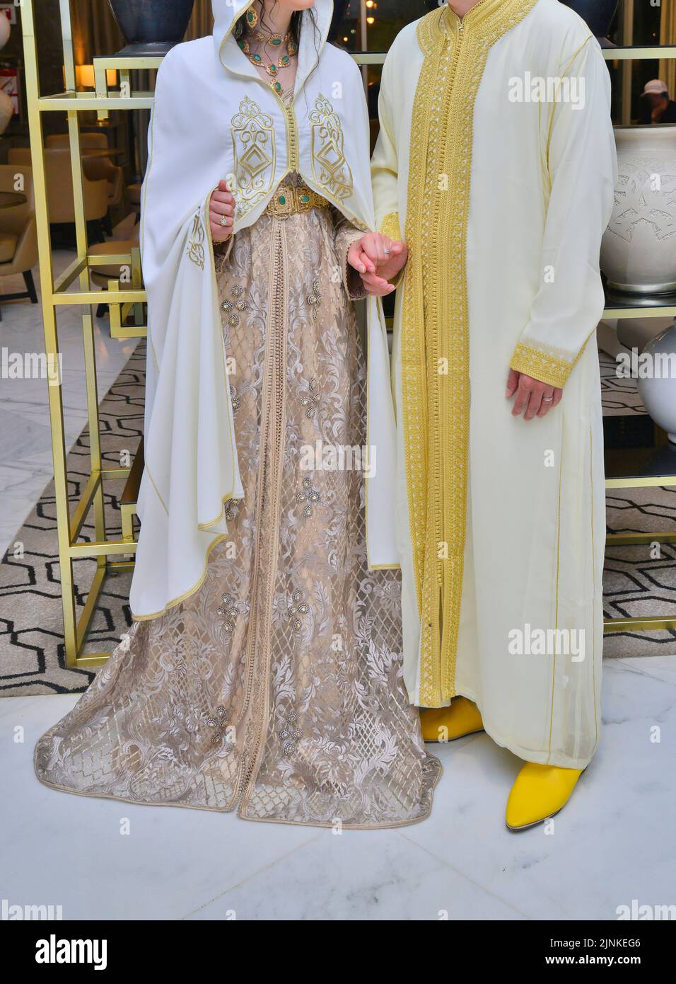 Moroccan wedding. A groom wearing a djellaba holds his bride who is wearing a traditional Moroccan caftan Stock Photo