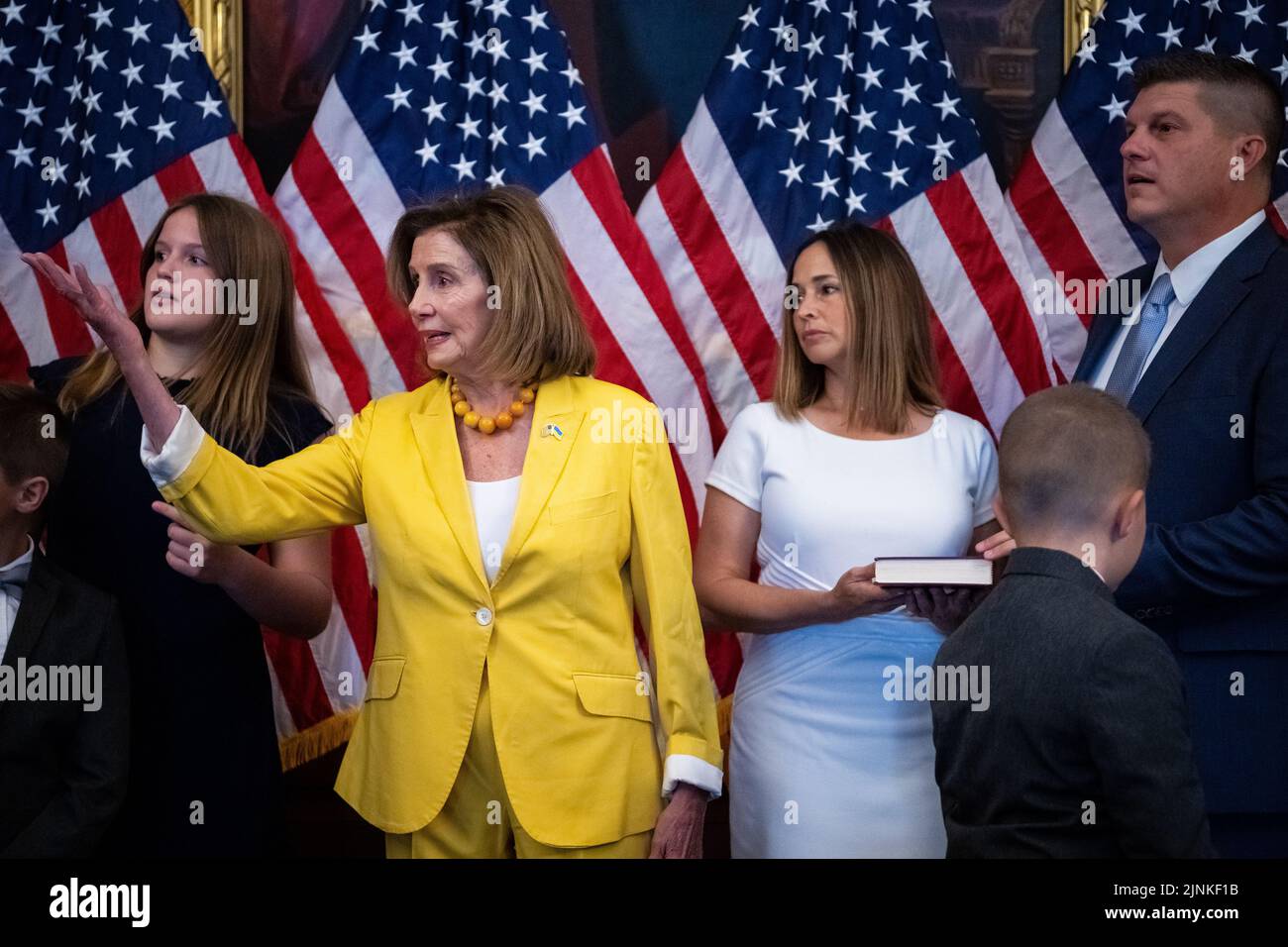 Washington, USA. 12th Aug, 2022. House Speaker Nancy Pelosi (D-CA) gestures prior to a ceremonial swearing-in for Congressman-elect Brad Finstad (R-MN), far-right, at the U.S. Capitol, in Washington, DC, on Friday, August 12, 2022. Today the House of Representatives returned from August recess to vote on the Inflation Reduction Act, a $739 billion tax-and-energy bill filled with Democrat priorities that the Senate passed last week with no Republican support. (Graeme Sloan/Sipa USA) Credit: Sipa USA/Alamy Live News Stock Photo