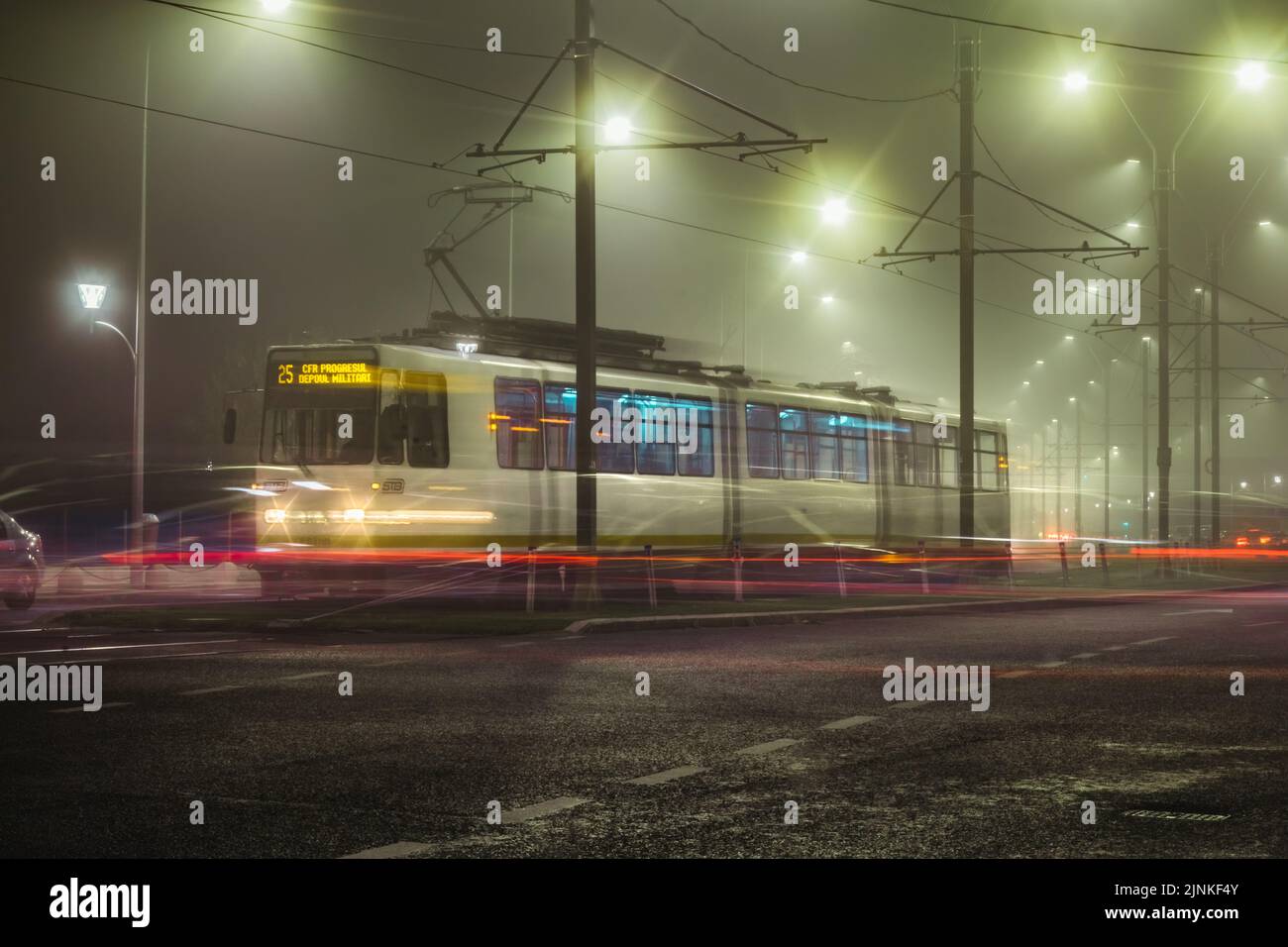 A tram in Bucharest, Romania on a foggy night taken with long exposure Stock Photo