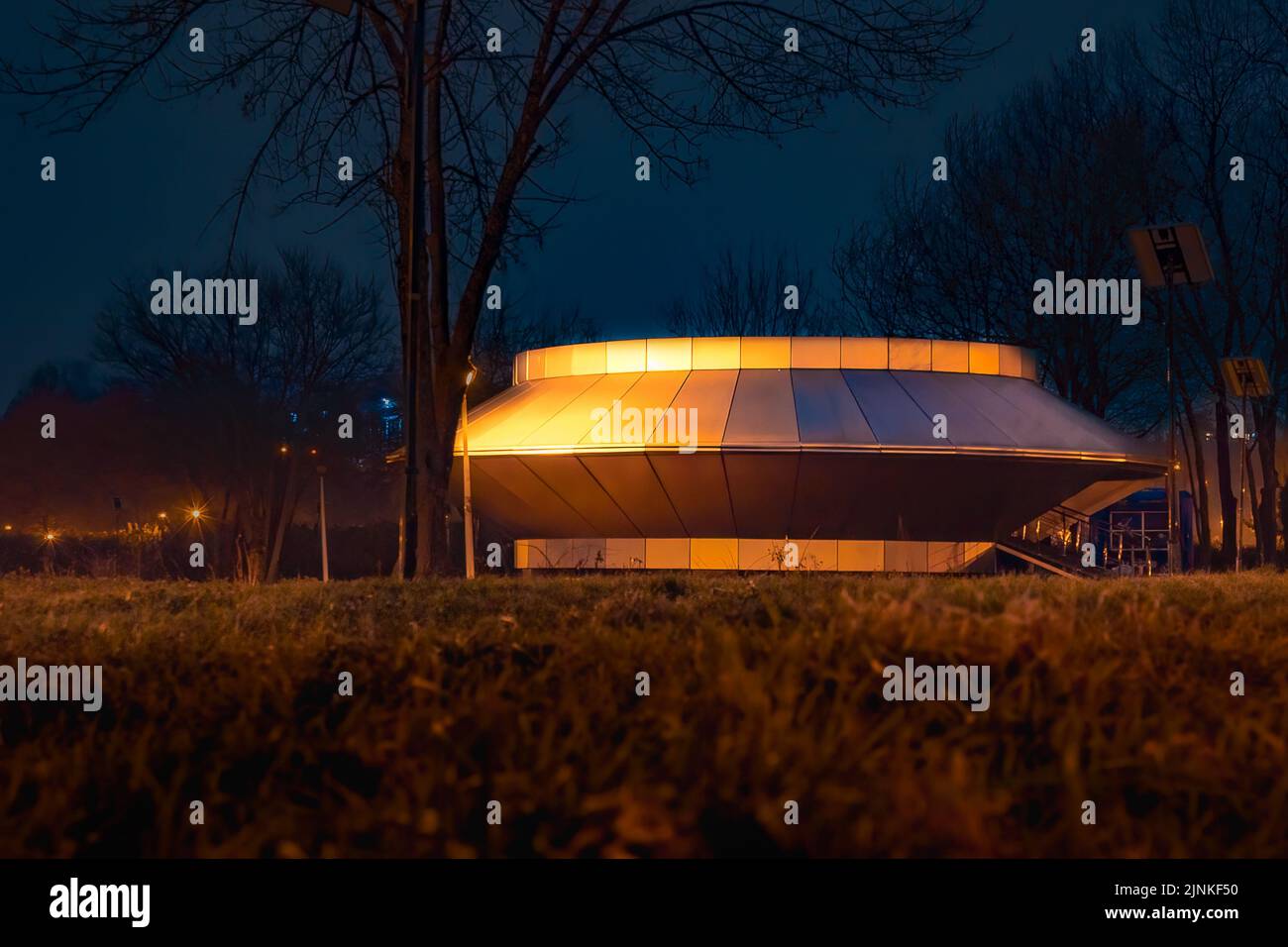 An UFO shaped construction in Tineretului Park, Bucharest at night Stock Photo