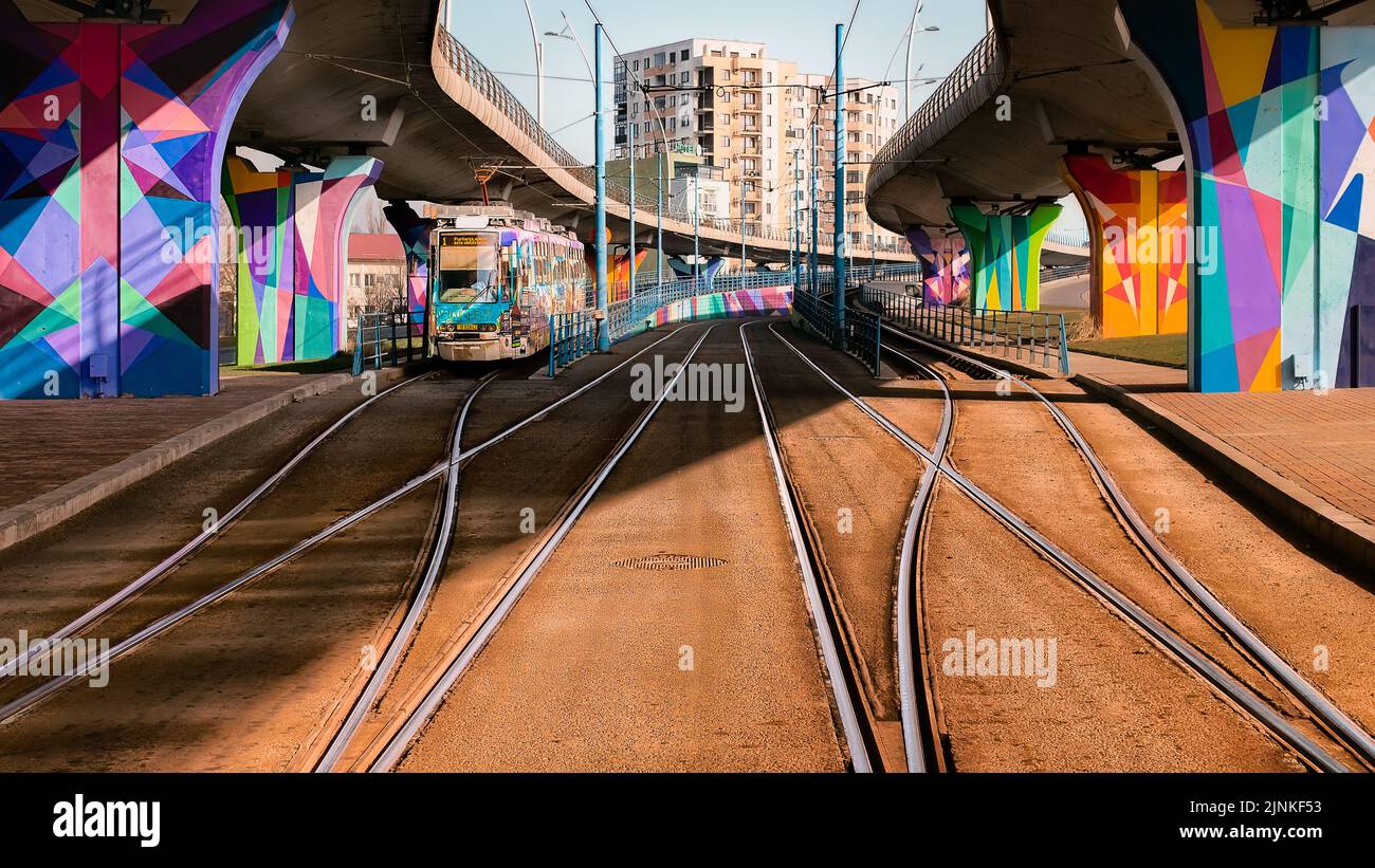 A tram passing under colorful passage at Regie in Bucharest Stock Photo