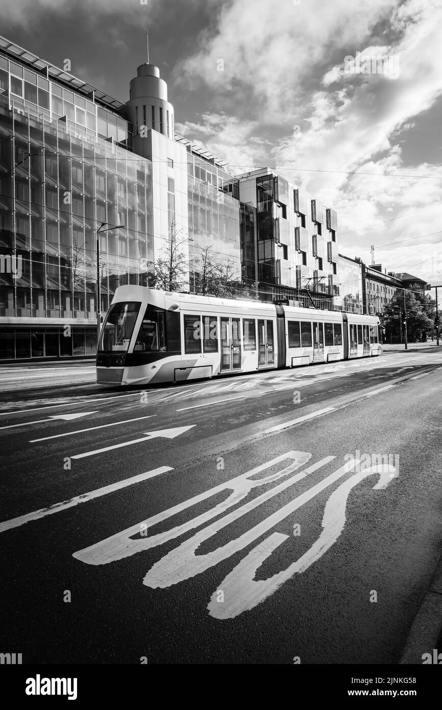 Modern Tallinn city tram with bus sign in the foreground. Stock Photo
