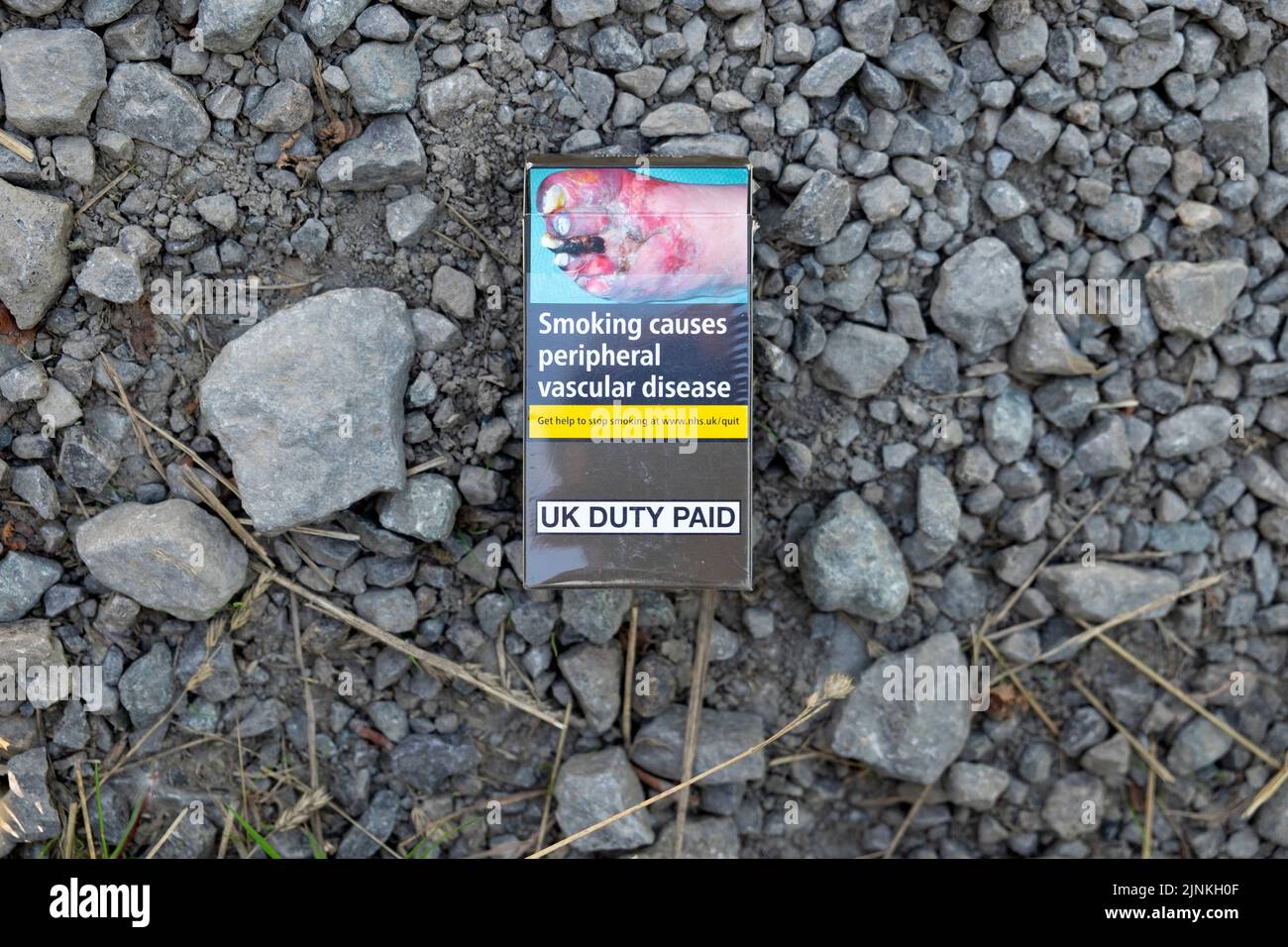 Health warning on cigarette packet pack diseased foot feet warning  for smokers 'Smoking causes peripheral vascular disease' Great Britain UK 2022 Stock Photo