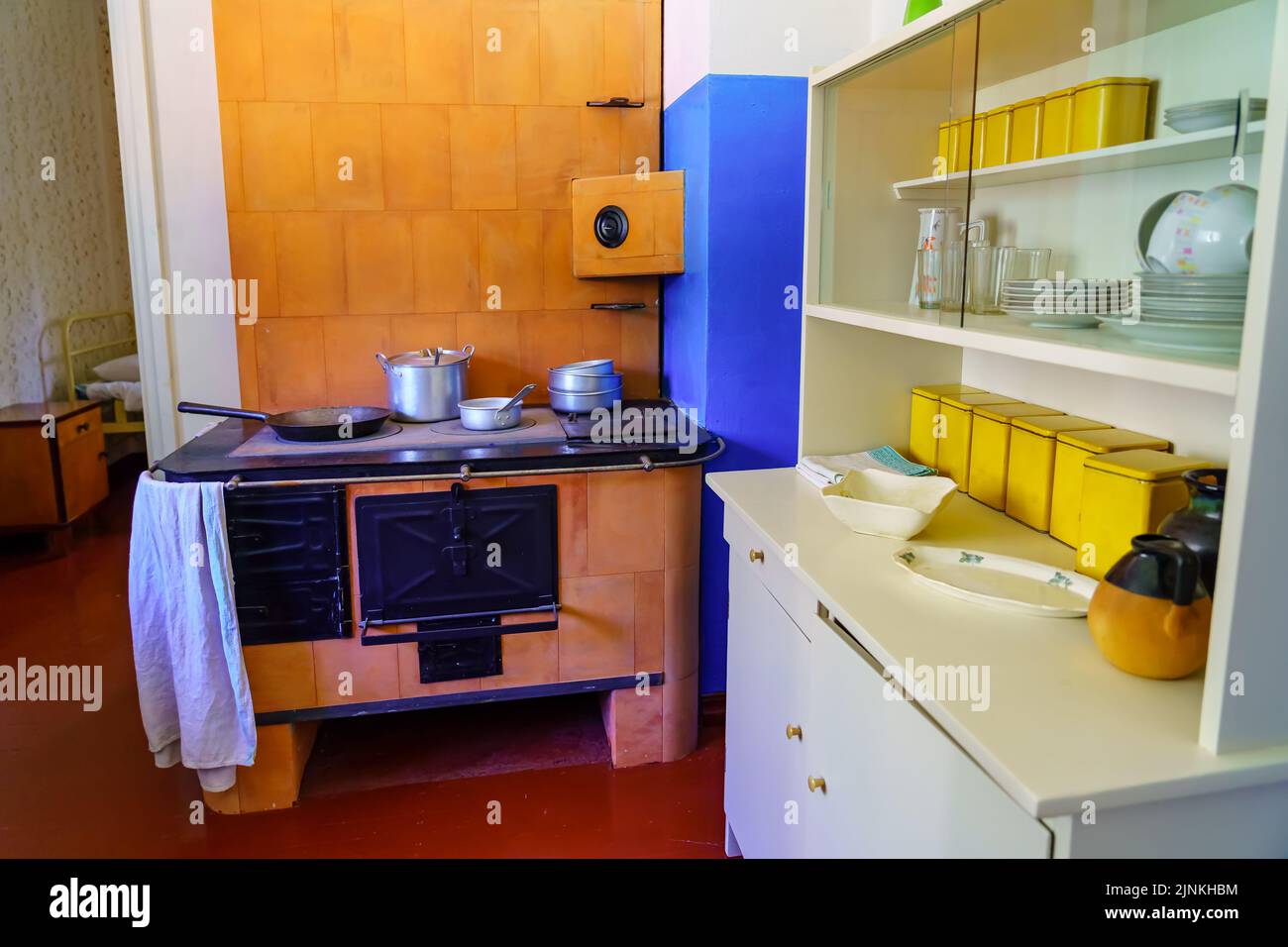 Old kitchen with metal oven and utensils from bygone eras. Stock Photo