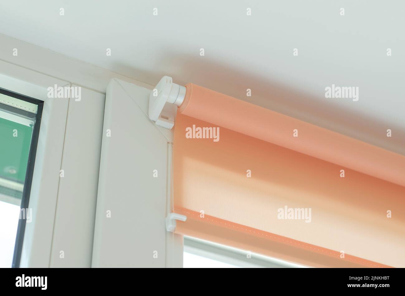 Roller blinds on the window. Fastening roller blinds to the window