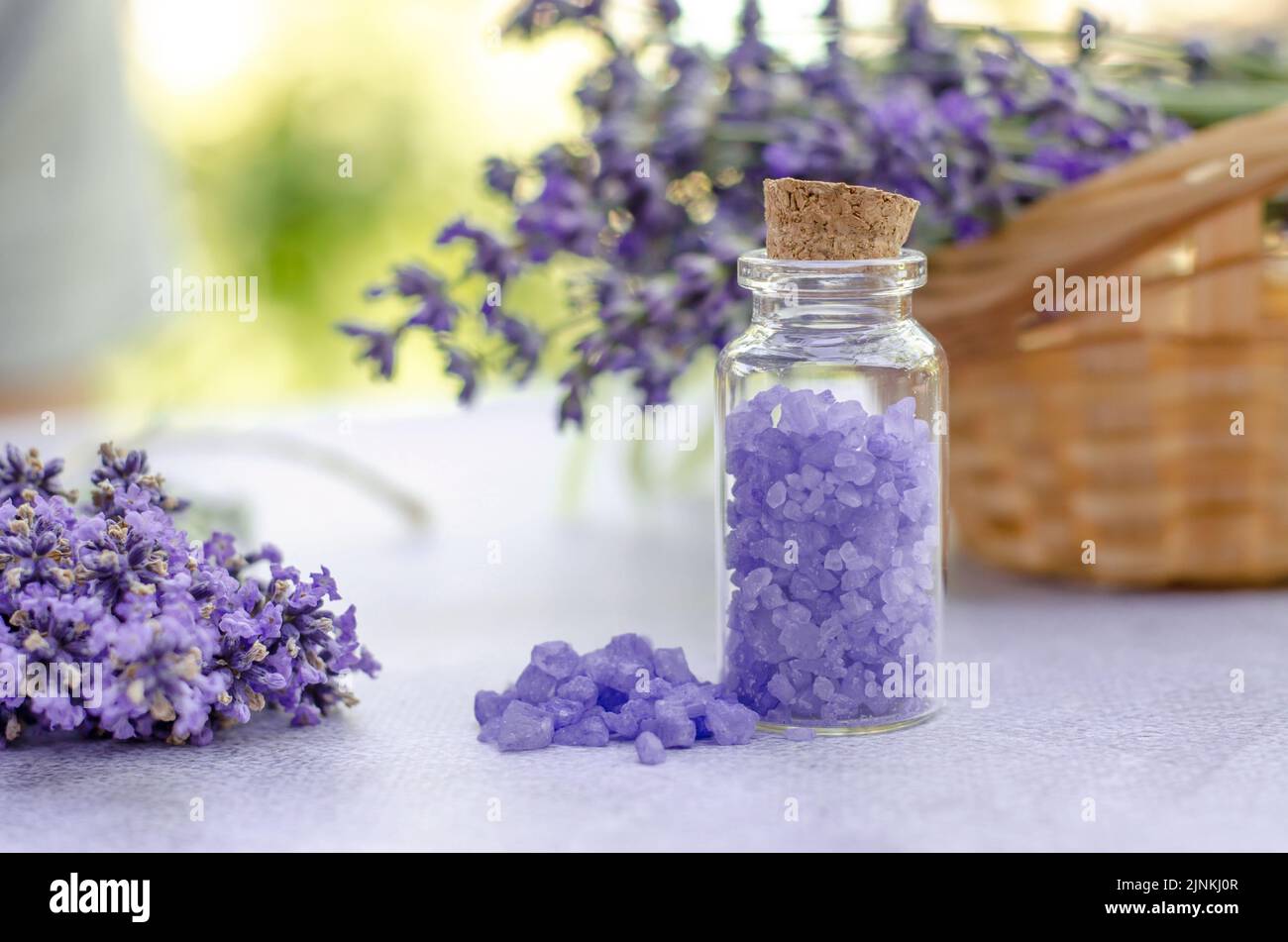 lavender oil and salt in glass bottle on background of dry lavender flowers.  Natural cosmetic Stock Photo by serenkonata
