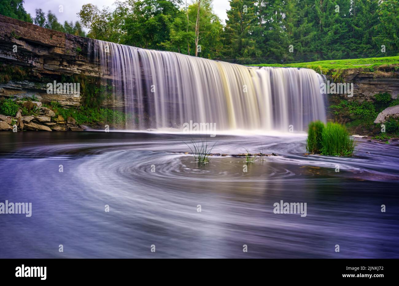 Great river waterfall swirling in the water in long exposure photo. Stock Photo
