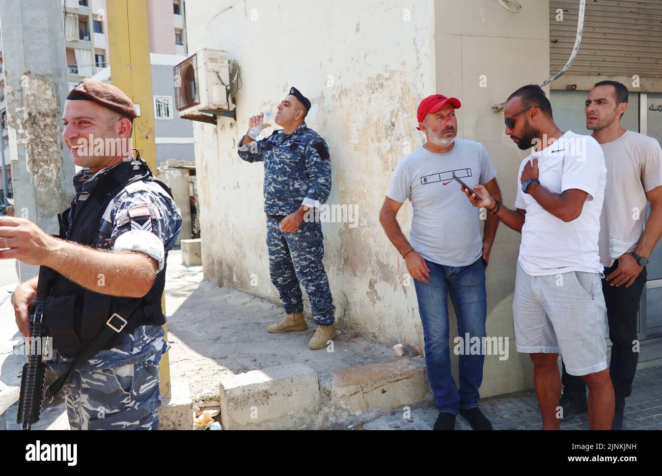 Atef al-Sheikh Hussein (red cap) is waiting for the release of his brother Bassam al-Sheikh Hussein, deteinee in the headquarter of Intelligence Police Department, Beirut, Lebanon, August 12 2022. On August 11 Bassam al-Sheikh entered the Federal Bank in Hamra district, Beirut, with a gun and some fuel threatening to set himself on fire unless he was allowed to take out his own money. According to Lebanese medias, the man wanted to withdraw his 210.000 USD deposit, which was frozen by the bank since the outbreak of the country's economic crisis in 2019. In the end the depositor surrendered and Stock Photo