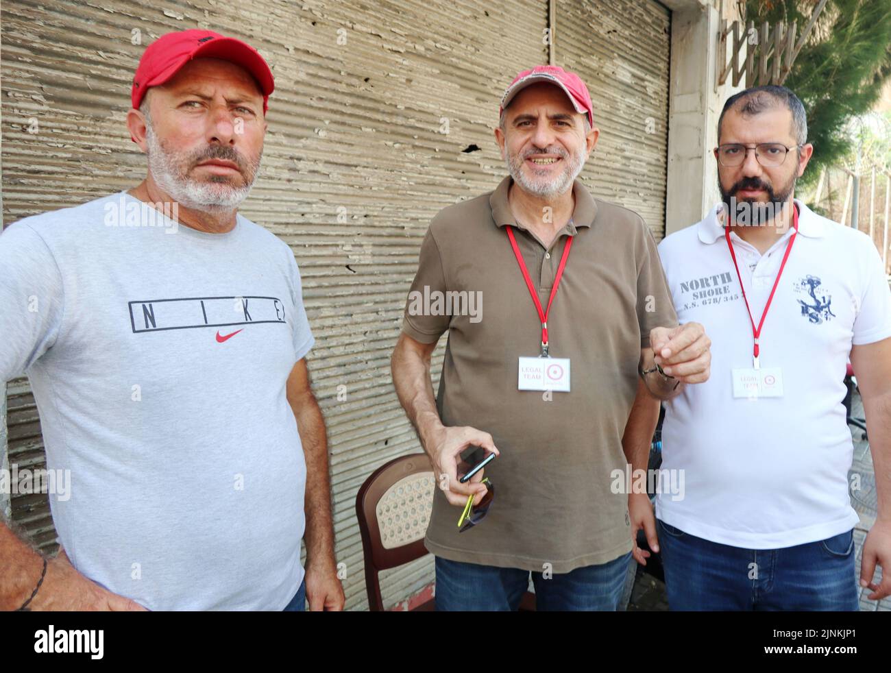 Brother Atef al-Sheikh Hussein (left) and his legal team wait for the release of Bassam al-Sheikh Hussein, deteinee in the headquarter of Intelligence Police Department, Beirut, Lebanon, August 12 2022. On August 11 Bassam al-Sheikh entered the Federal Bank in Hamra district, Beirut, with a gun and some fuel threatening to set himself on fire unless he was allowed to take out his own money. According to Lebanese medias, the man wanted to withdraw his 210.000 USD deposit, which was frozen by the bank since the outbreak of the country's economic crisis in 2019. In the end the depositor surrender Stock Photo