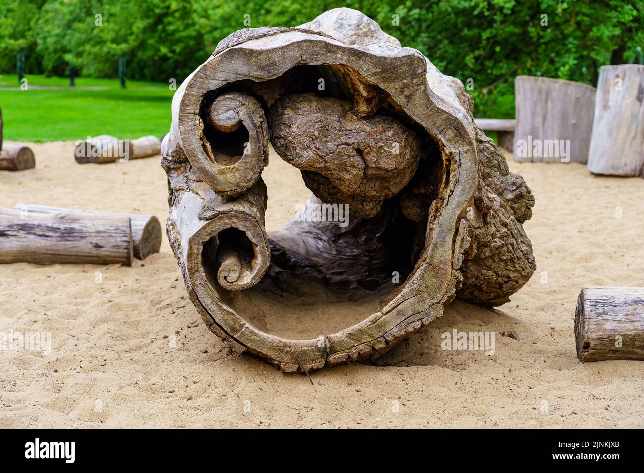 Hollow log in a playground for children to play with. Stock Photo