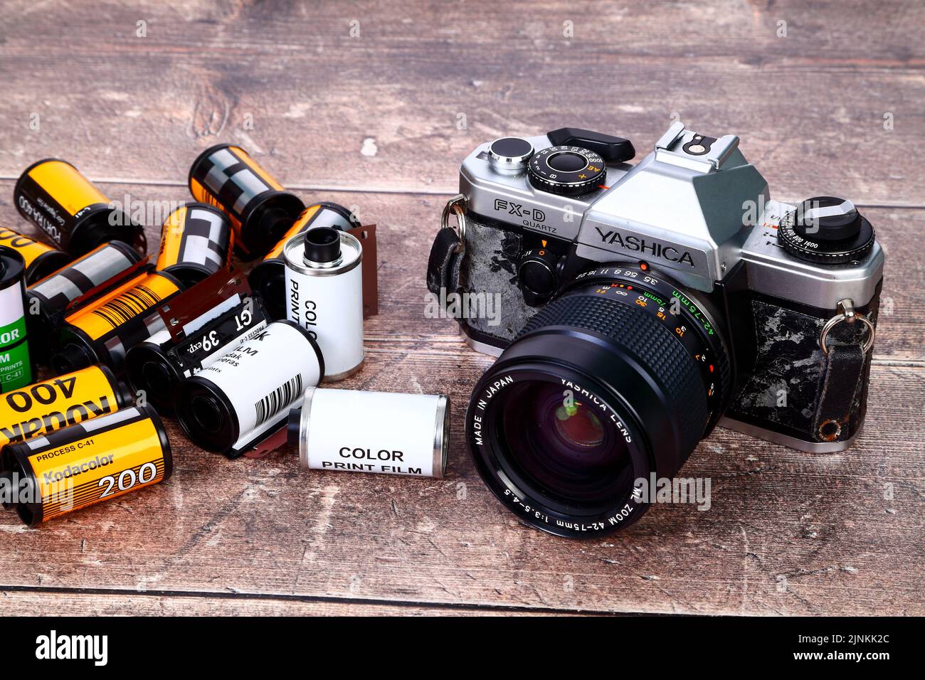 Old battered SLR camera with 35mm film rolls For editorial use only Stock Photo