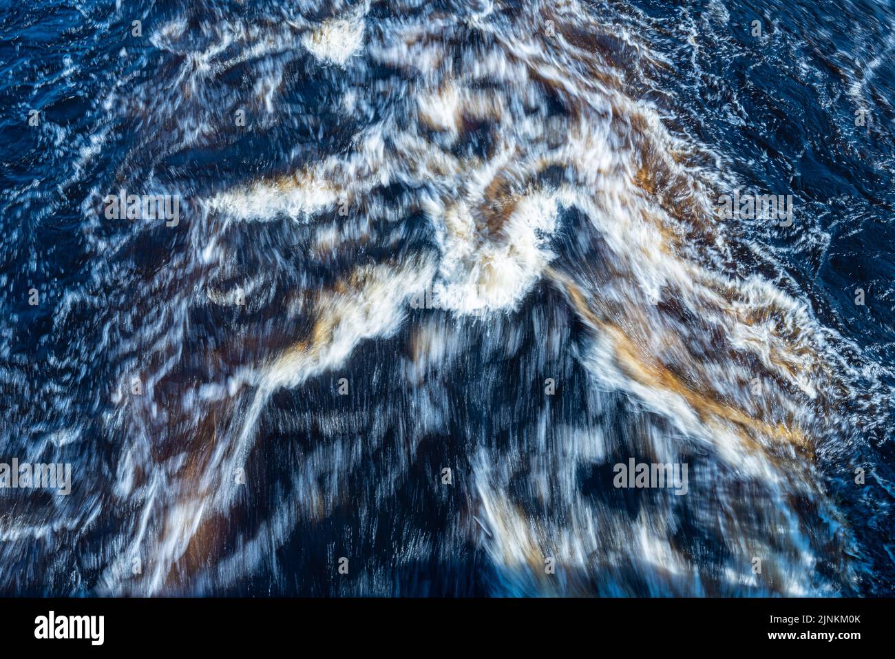 Brown water rushing down a river Stock Photo - Alamy