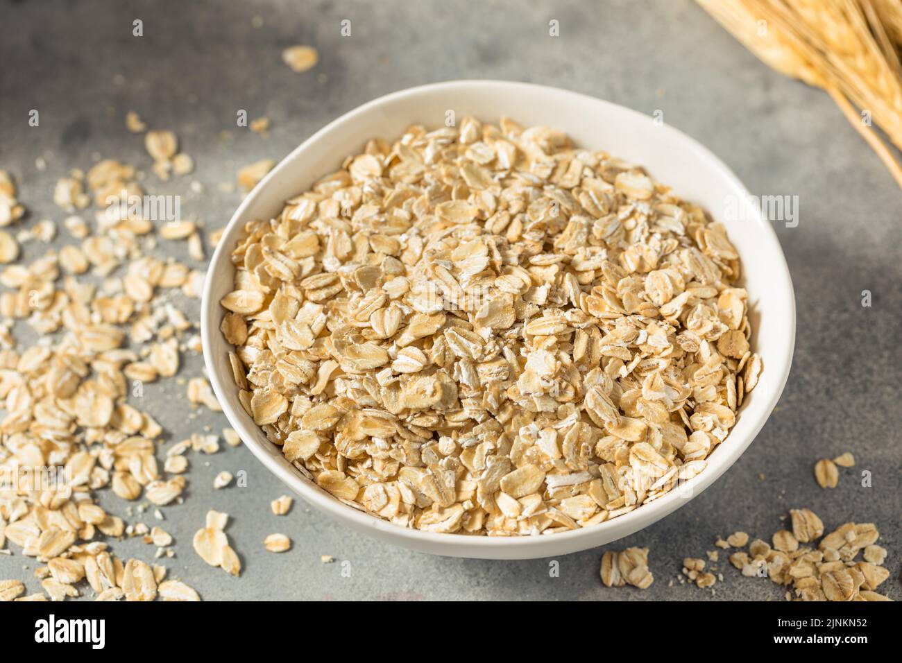 Dry Organic Rolled Oats Oatmeal in a Bowl Stock Photo