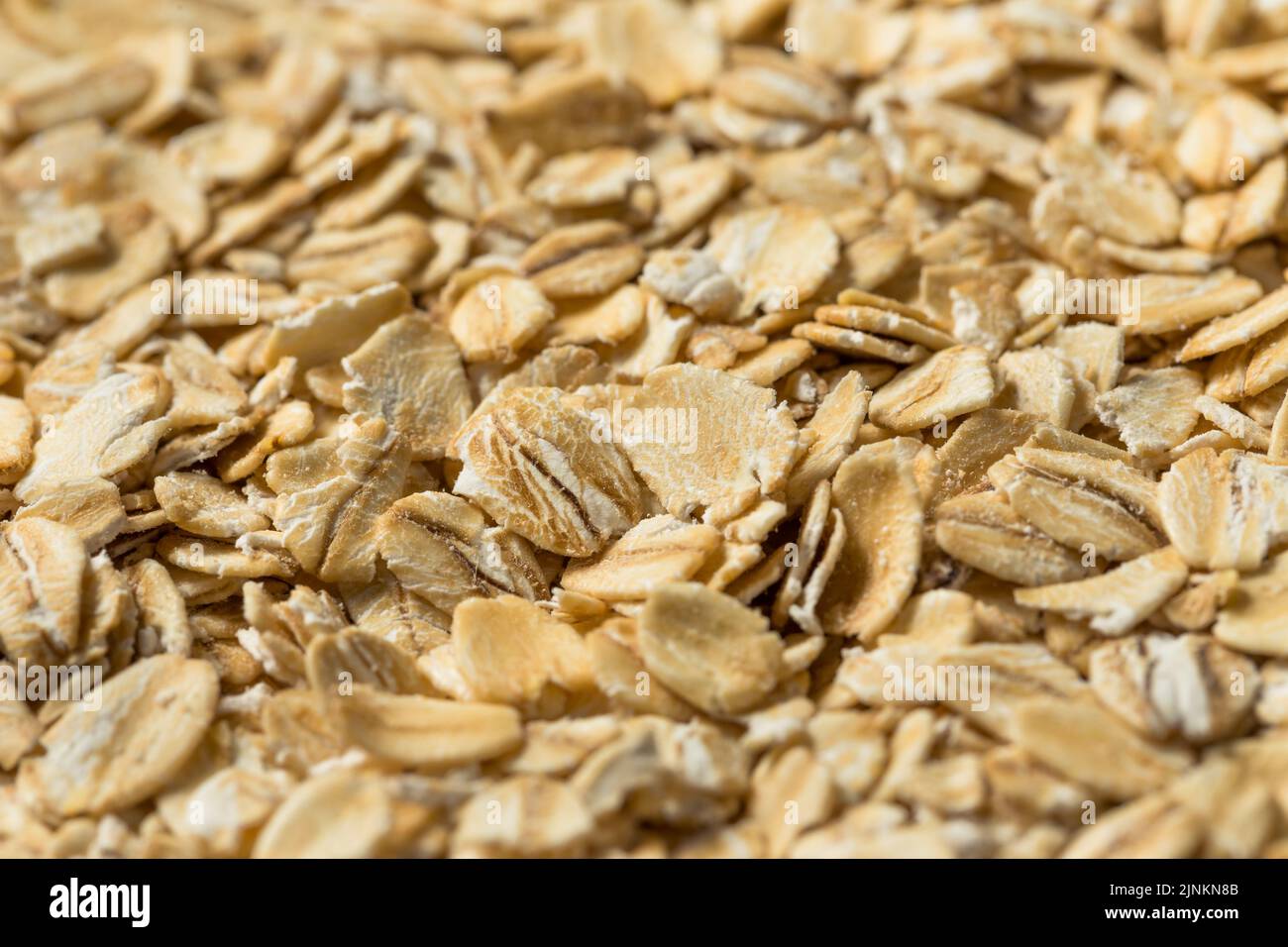 Dry Organic Rolled Oats Oatmeal in a Bowl Stock Photo
