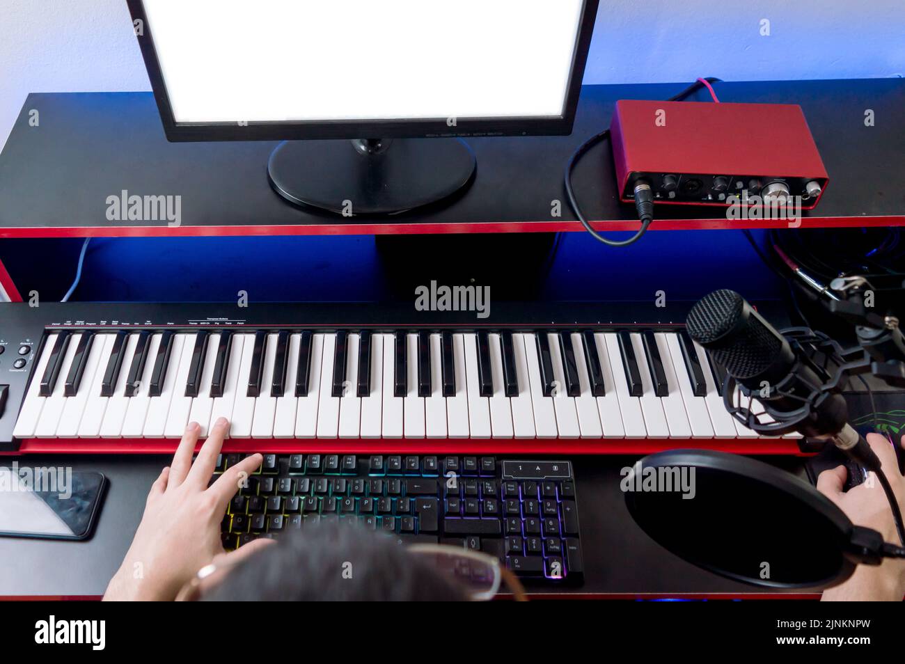 overhead view music producer at work mixing urban pop music at home