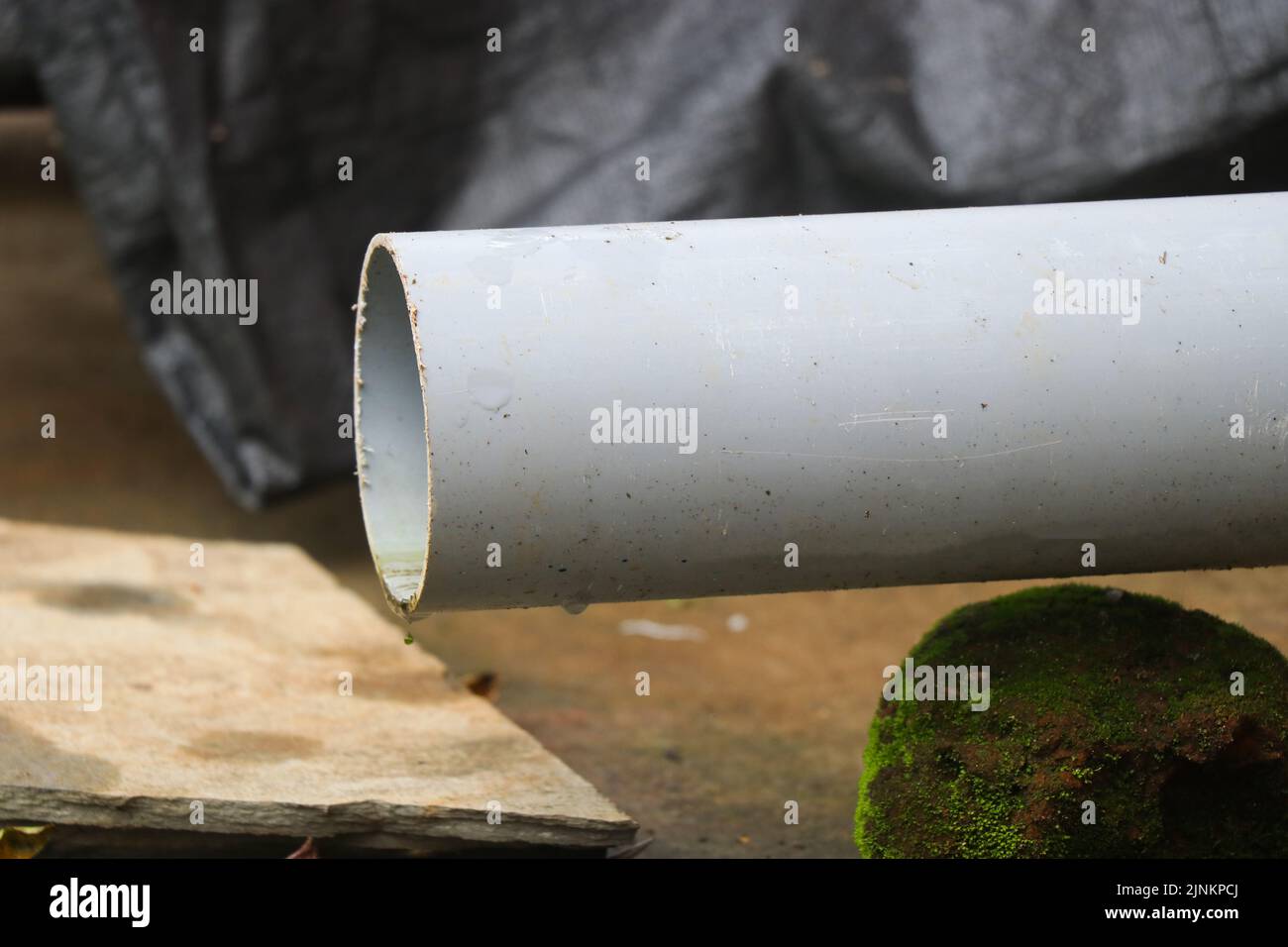 Medium size PVC pipe or hose used as water drainage with a close view Stock Photo