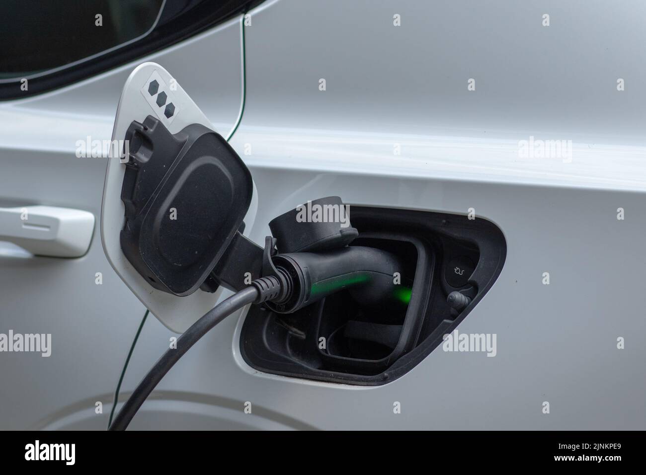 Electric car charging electricity with a black port Stock Photo Alamy