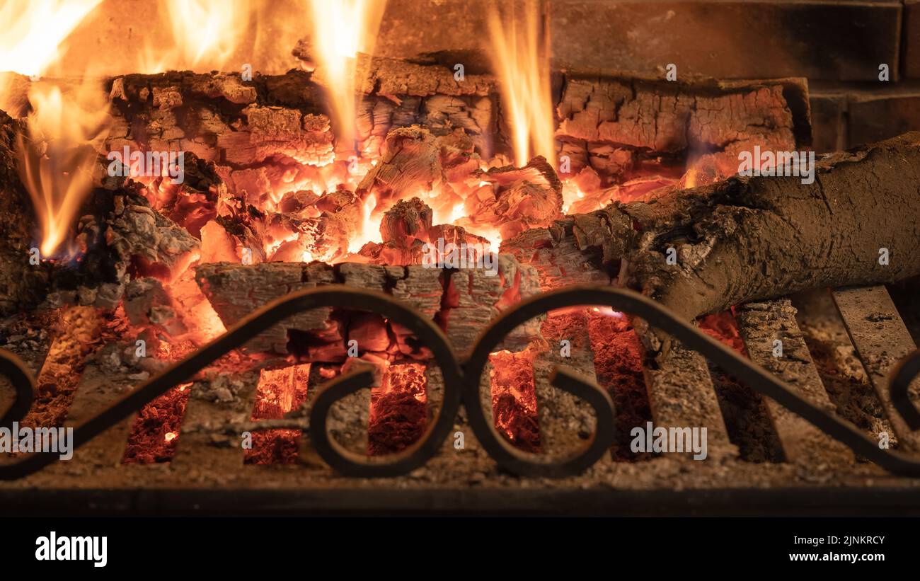 Wood embers in a fireplace giving comfortable warmth in winter. Stock Photo