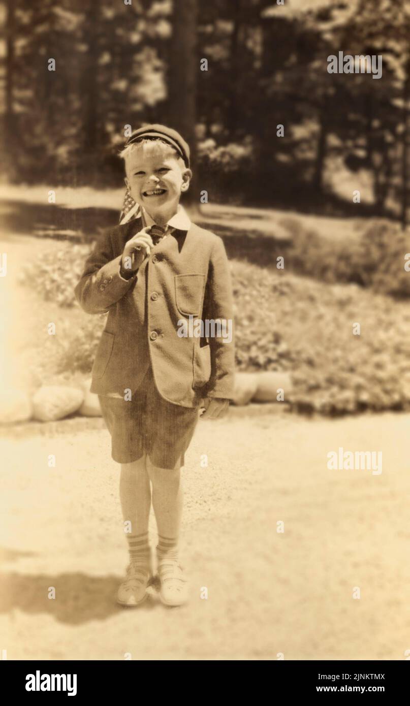 Antique circa 1930 photograph, boy with stick fishing pole on dock with fish.  Exact location unknown, USA. SOURCE: ORIGINAL PHOTOGRAPH Stock Photo - Alamy