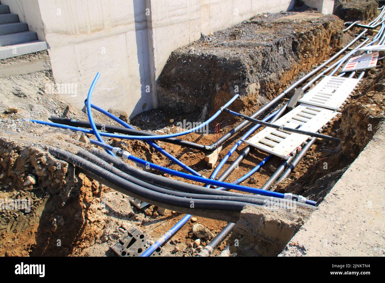 Material to secure a construction site fell into the excavation after a storm Stock Photo
