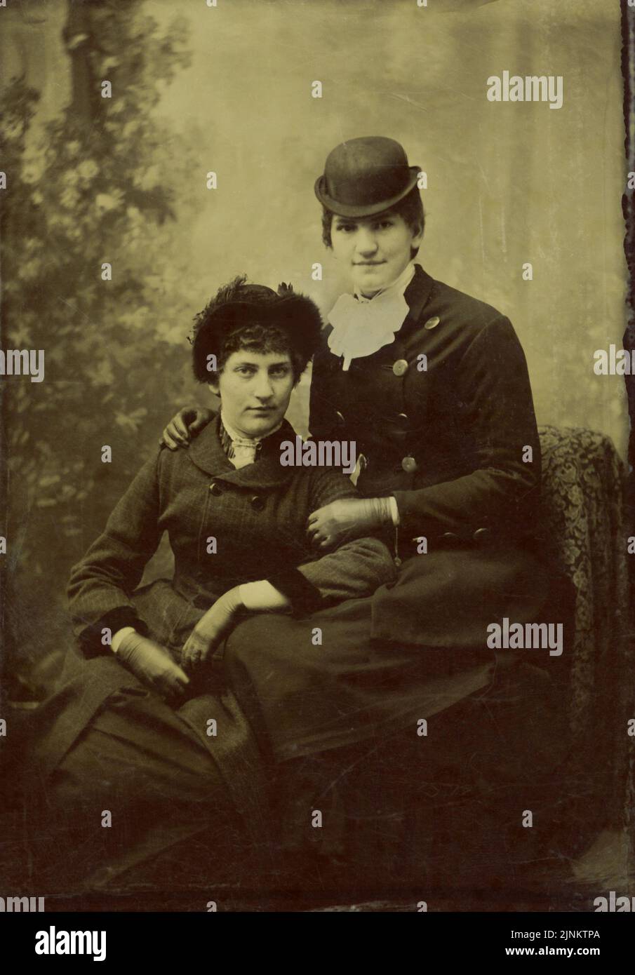 Victorian tintype black and white studio photo portrait of two women wearing attire from the mid to late nineteenth century circa 1870s Stock Photo