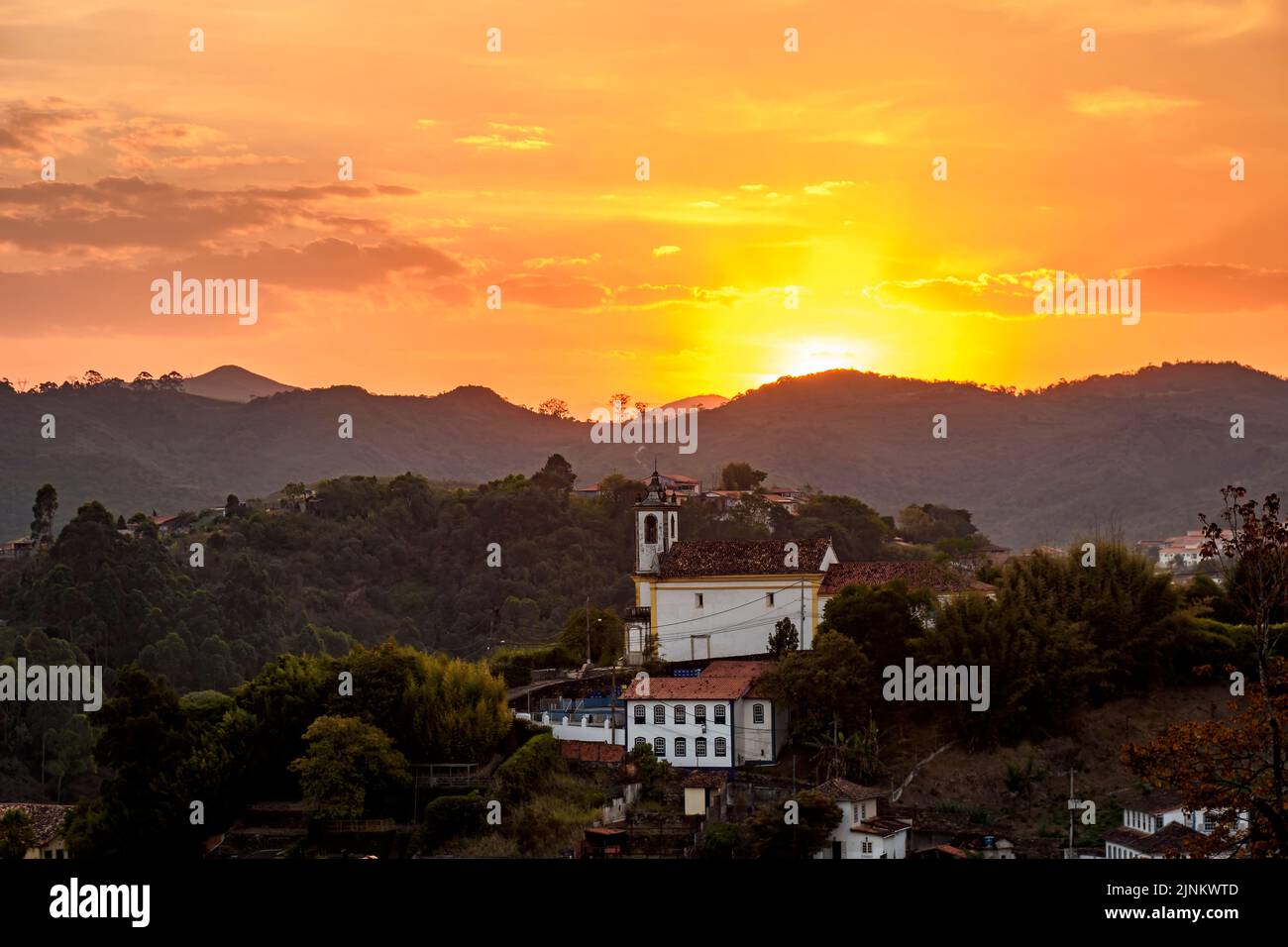 Old historic colonial church among the mountains of Ouro Preto city during sunset Stock Photo