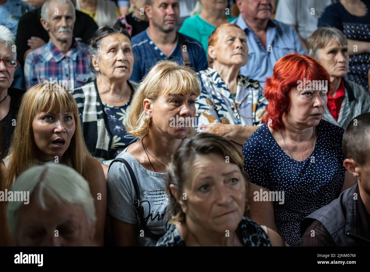 People attending a Sunday service in a Catholics church in Slovyansk, Donbas. Despite the city being continuously heavily bombarded by Russian artilleries and missiles, some residents still plan to stay in the city of Slovyansk which had a population of 106,972 (2021 est.), now stands as a main strategic city in the Donetsk region of Donbas. Since the war started, over 80% of the civilian have been evacuated from the war. Stock Photo