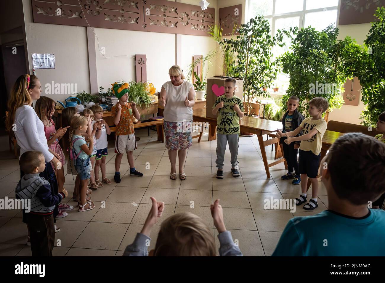 Children seen attending a Sunday children's service in a Catholics church in Slovyansk, Donbas. Despite the city being continuously heavily bombarded by Russian artilleries and missiles, some residents still plan to stay in the city of Slovyansk which had a population of 106,972 (2021 est.), now stands as a main strategic city in the Donetsk region of Donbas. Since the war started, over 80% of the civilian have been evacuated from the war. Stock Photo