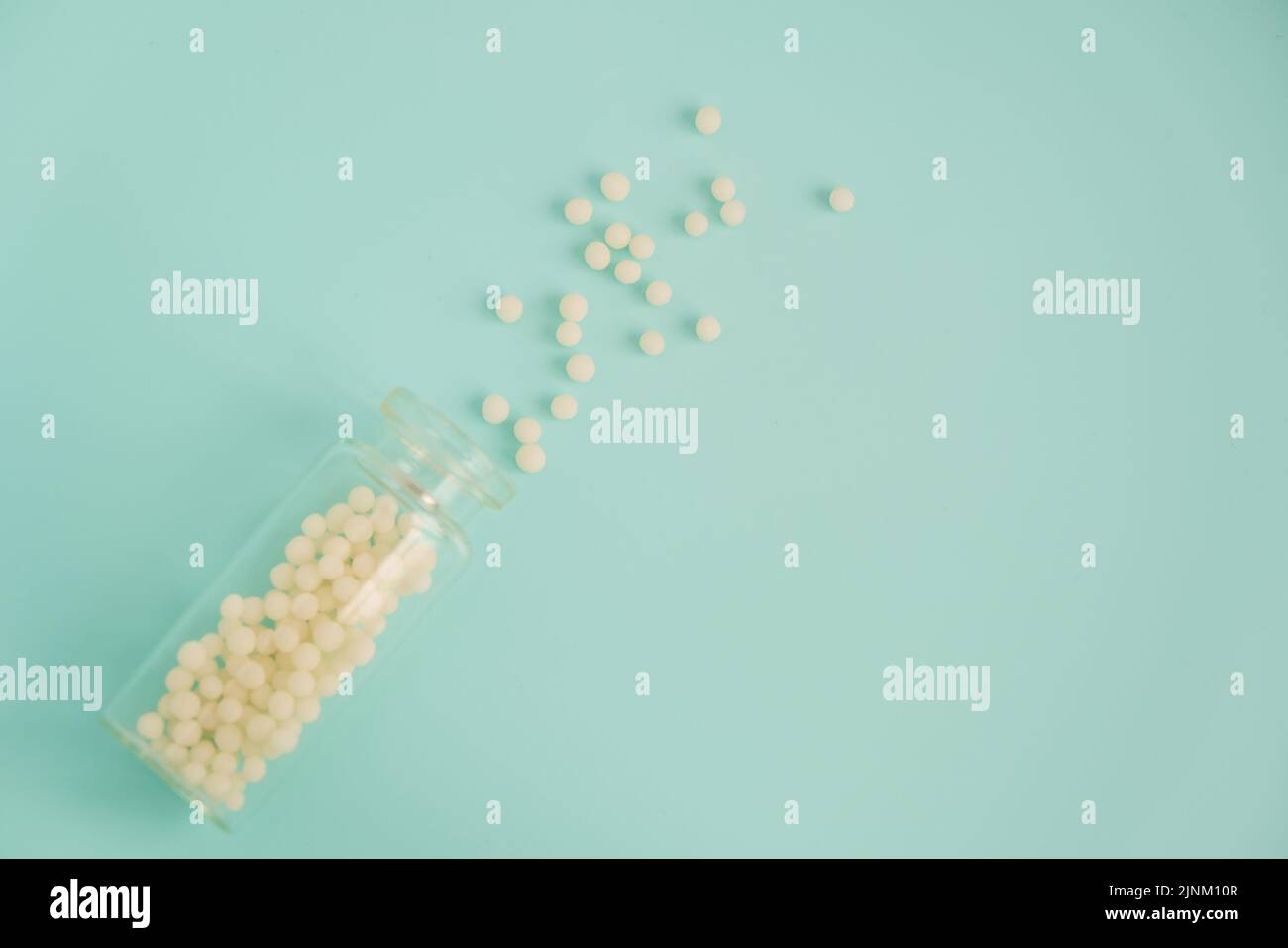 Alternative homeopathy medicine concept. Homeopathic globules scattered ...