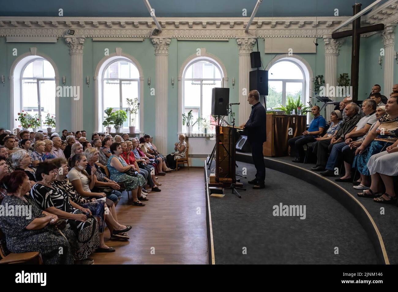 The priest, Yuri preaches the bible during a Sunday service in a