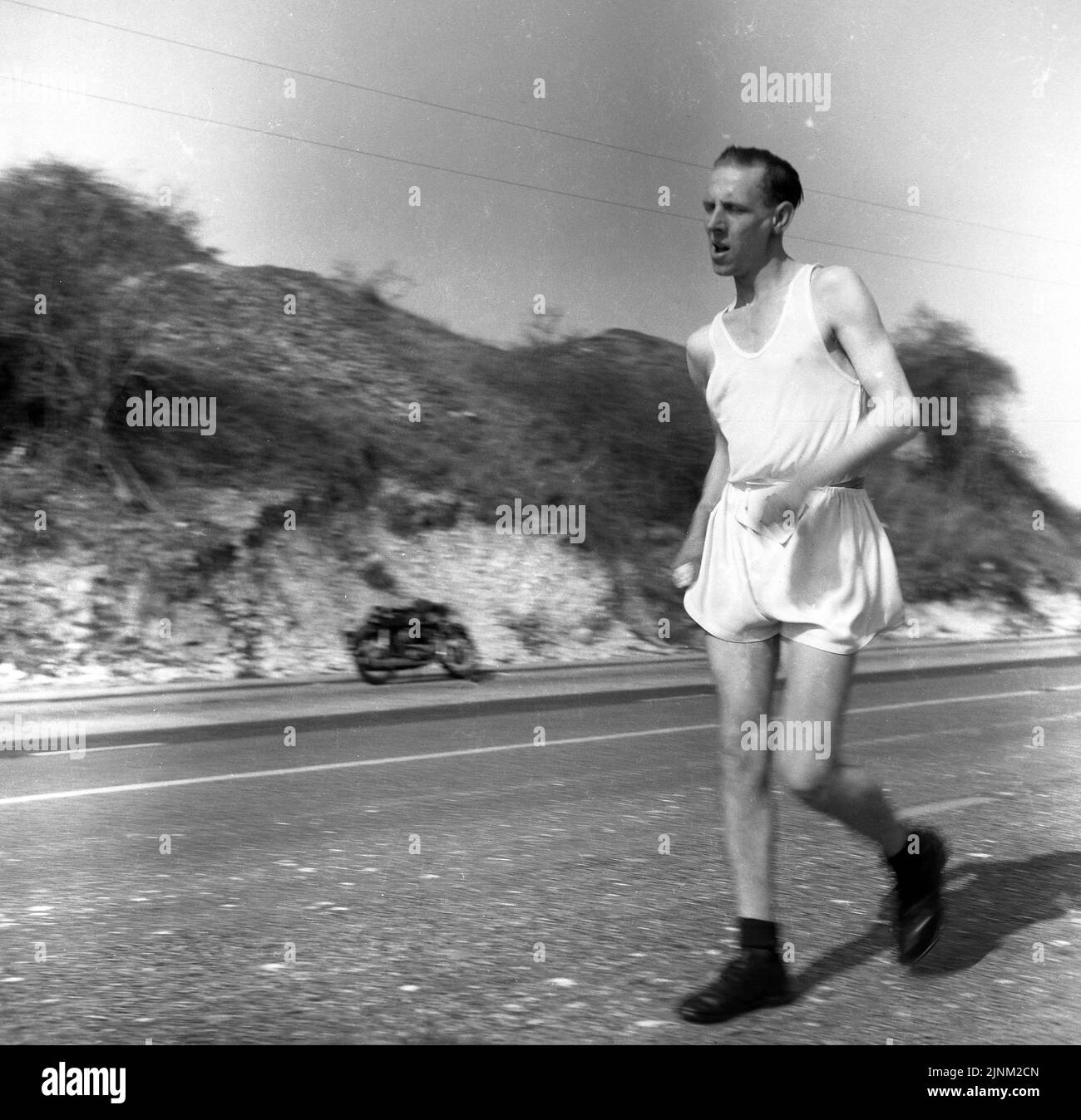1960, historical, a long distance race walker on a training session on the Brighton Rd, East Sussex, England, UK Stock Photo